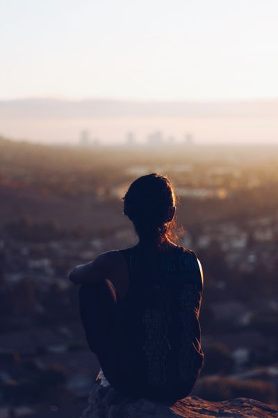 Woman sitting on a ledge